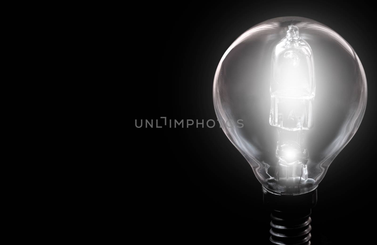 Brightly lit bulb on background with space 