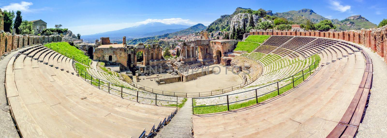 view of the ancient theater in Taormina with volcano Etna in the by rarrarorro