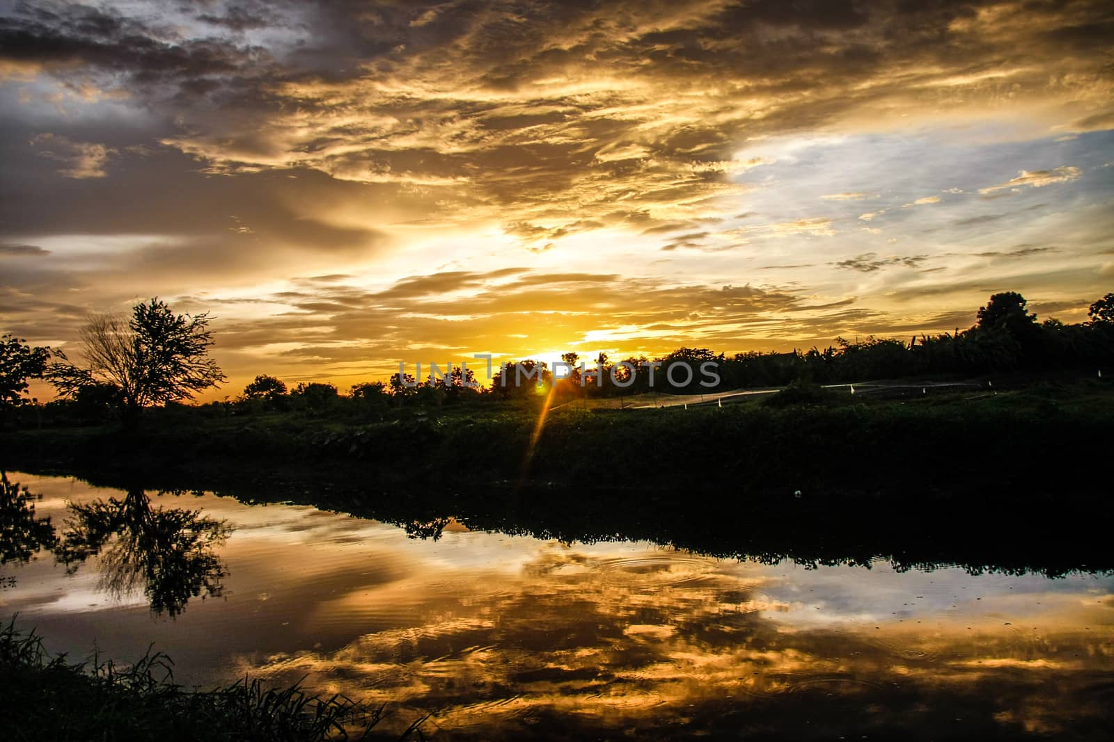 orange sky reflect on canal in evening