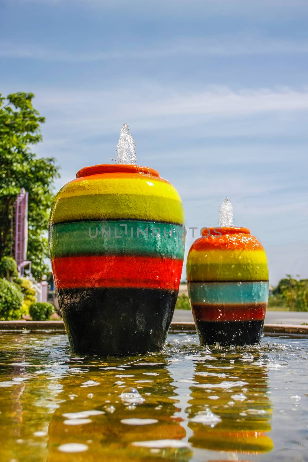 colorful jar pot fountain in pond