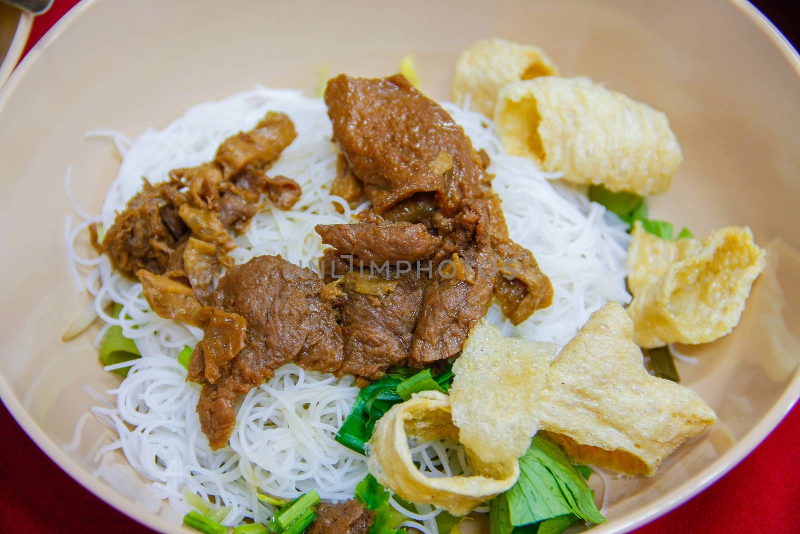 noodles soup with vegetable chicken, fried pork skin,  rice noodle on bowl