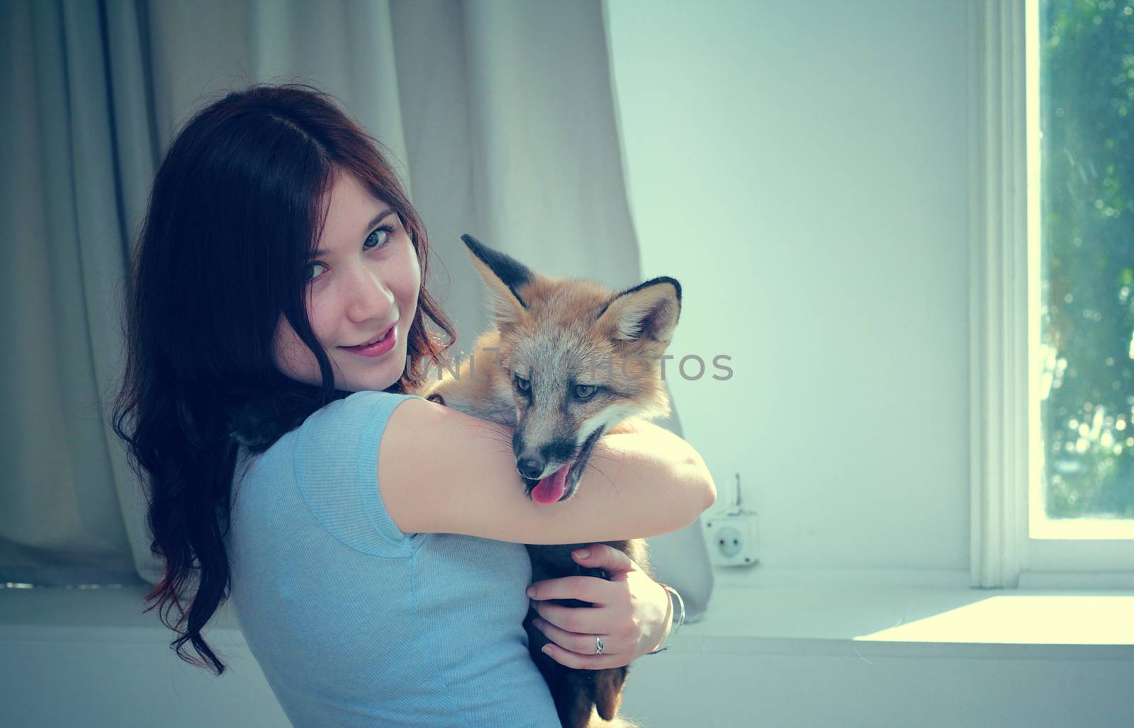 The girl is hugging the fox. by andsst
