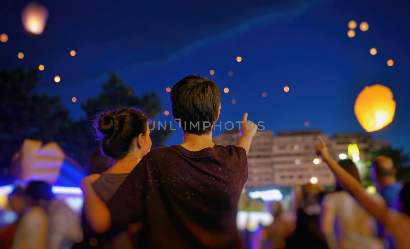 Teens in summer night with paper lantern