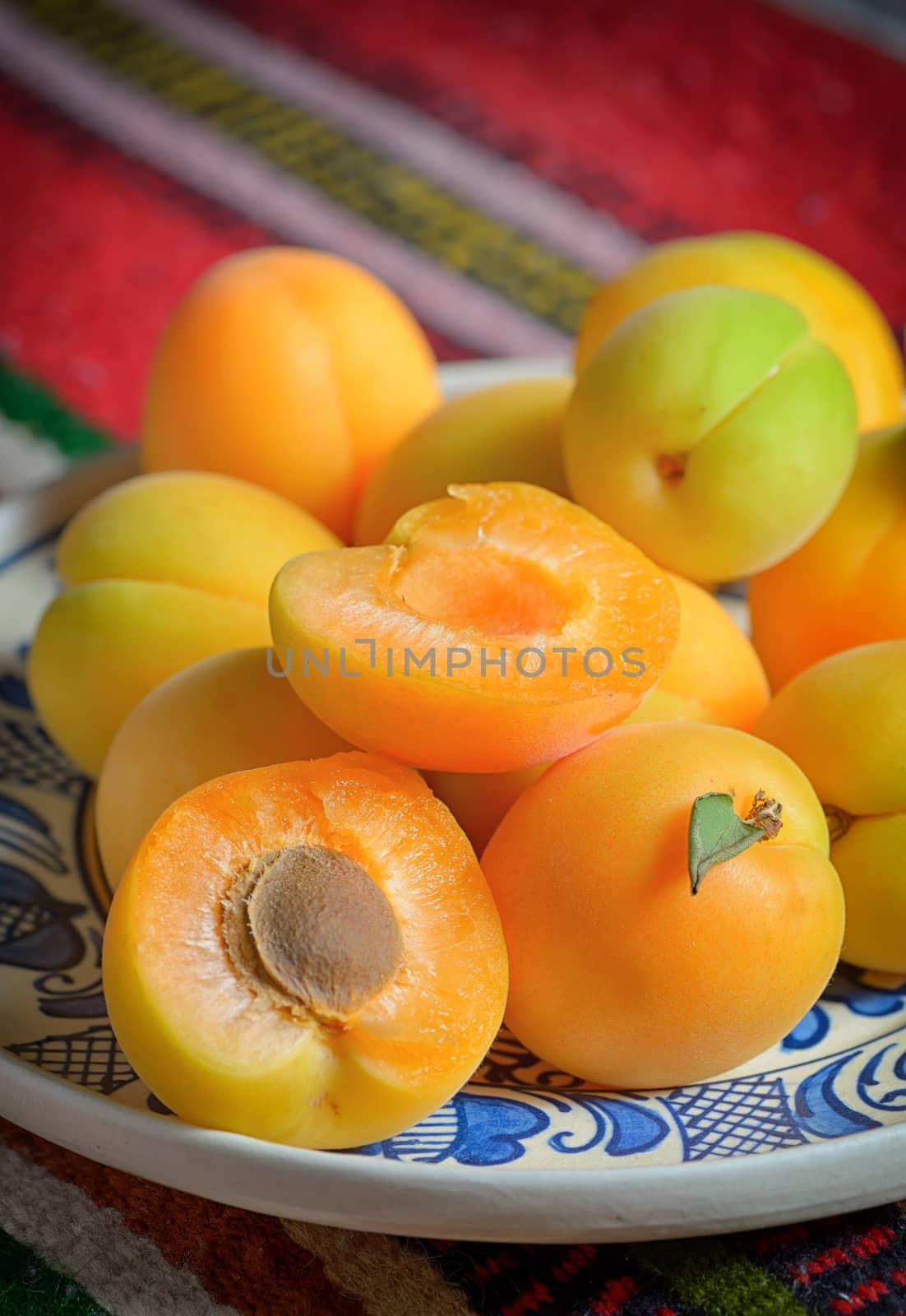 Ripe apricots fruits on rustic plate