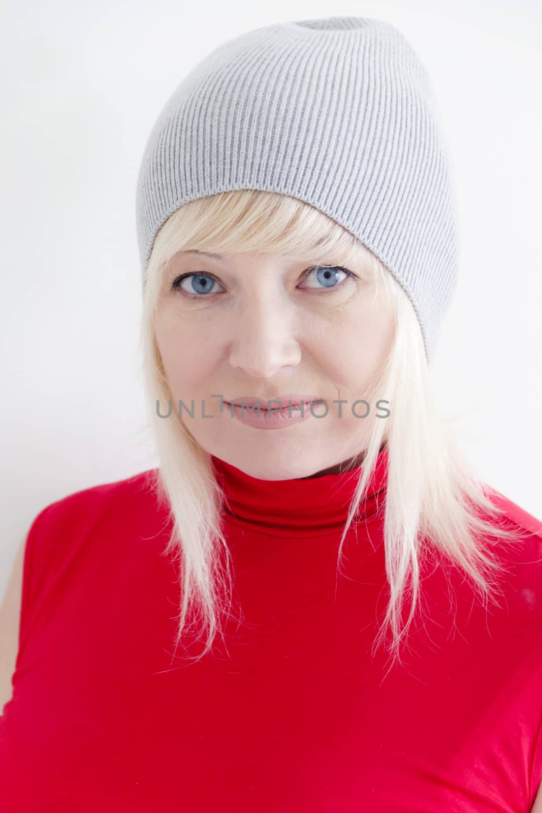 vertical portrait of blond woman with blue eyes in red