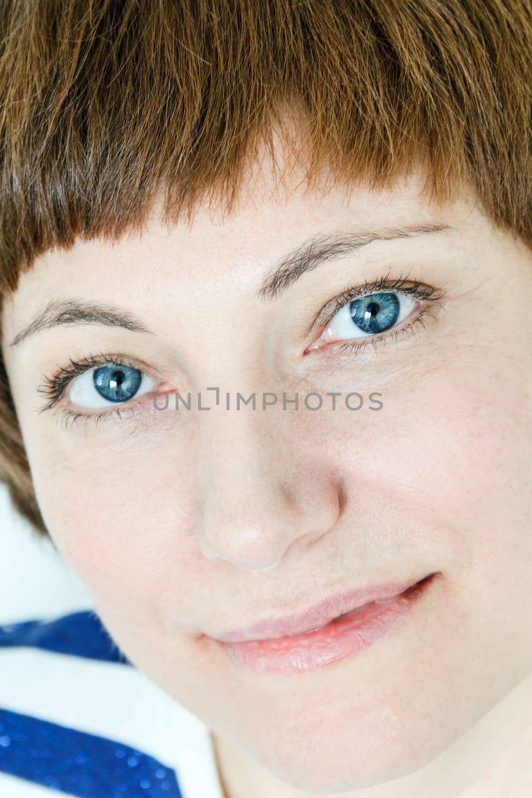 Portrait of smiling woman with short brown hair and blue eyes