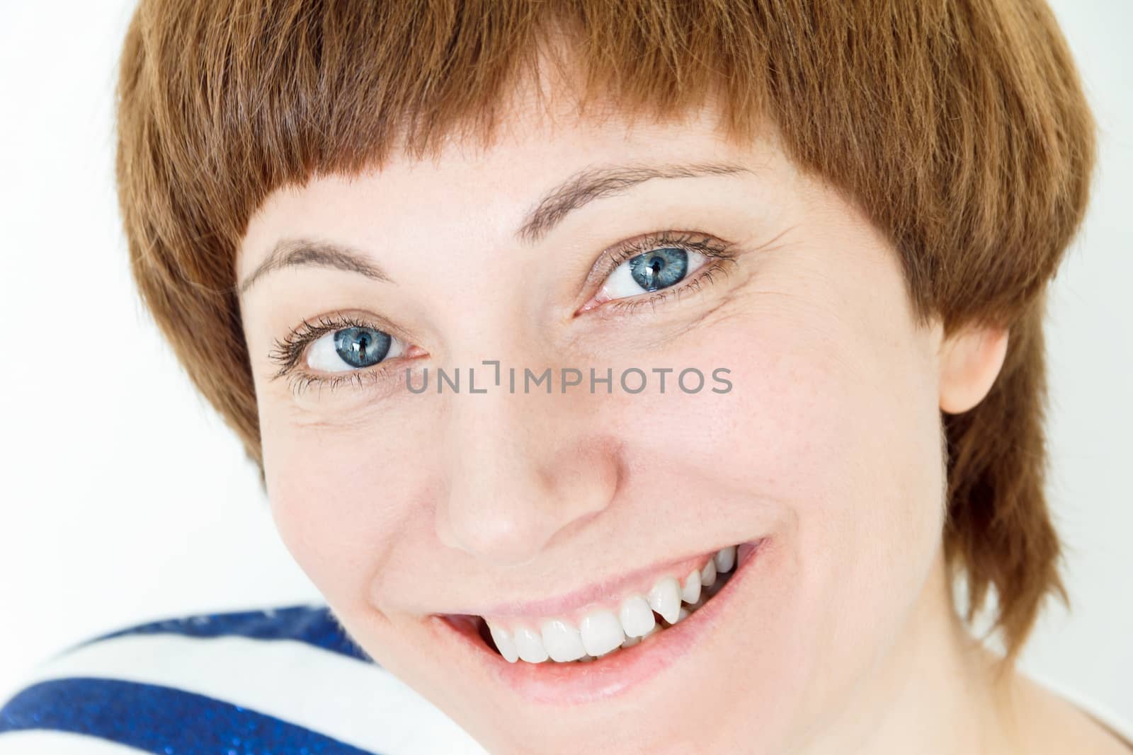 Portrait of smiling woman with short brown hair and blue eyes