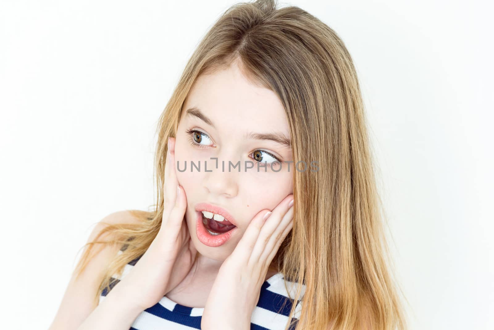 Surprised girl with blond long hair and green eyes on white