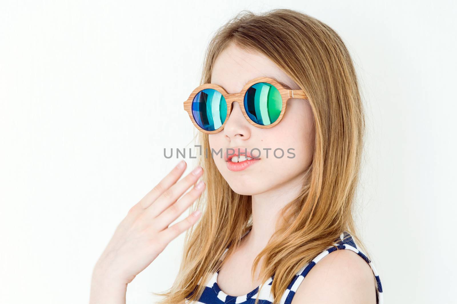 Portrait of  blond girl in green sunglasses on white