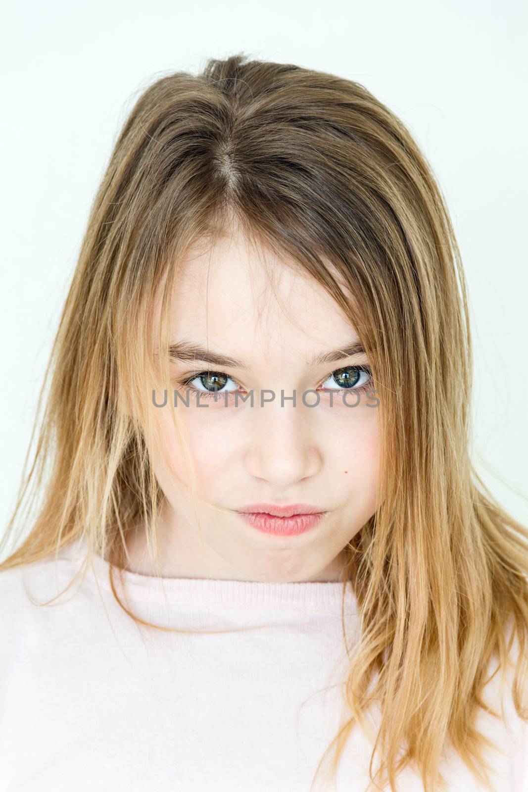 Cute girl eleven years old with blond long hair and green eyes