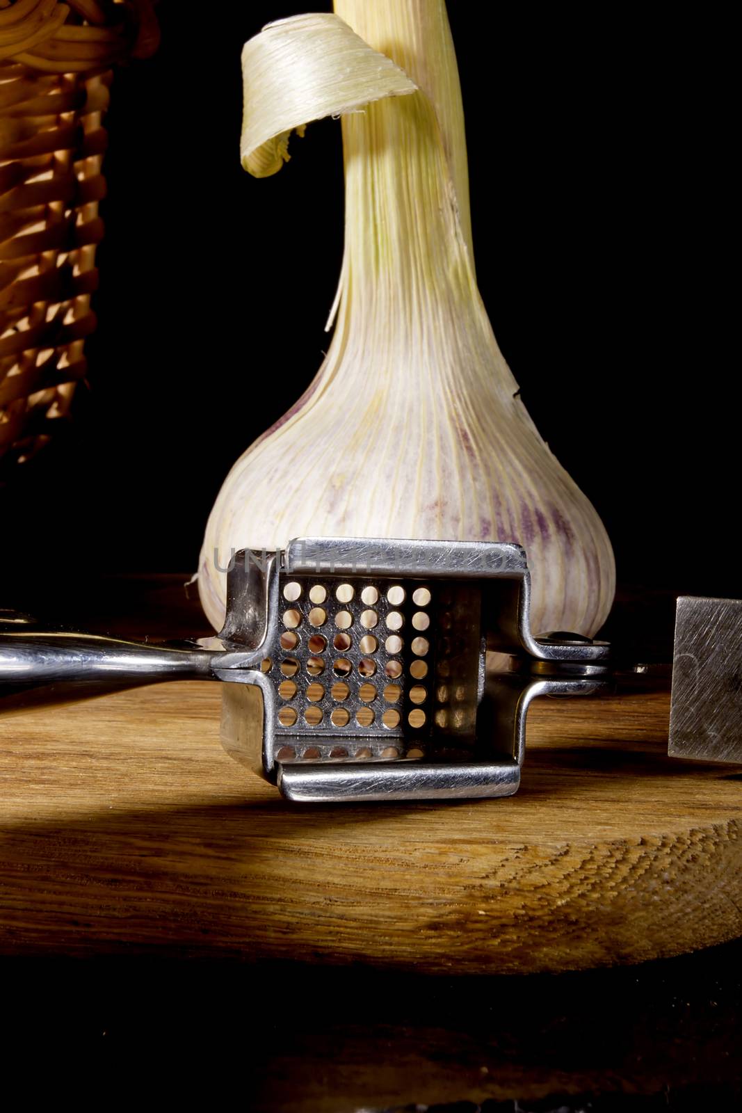 Garlic press and cloves of garlic by VIPDesignUSA