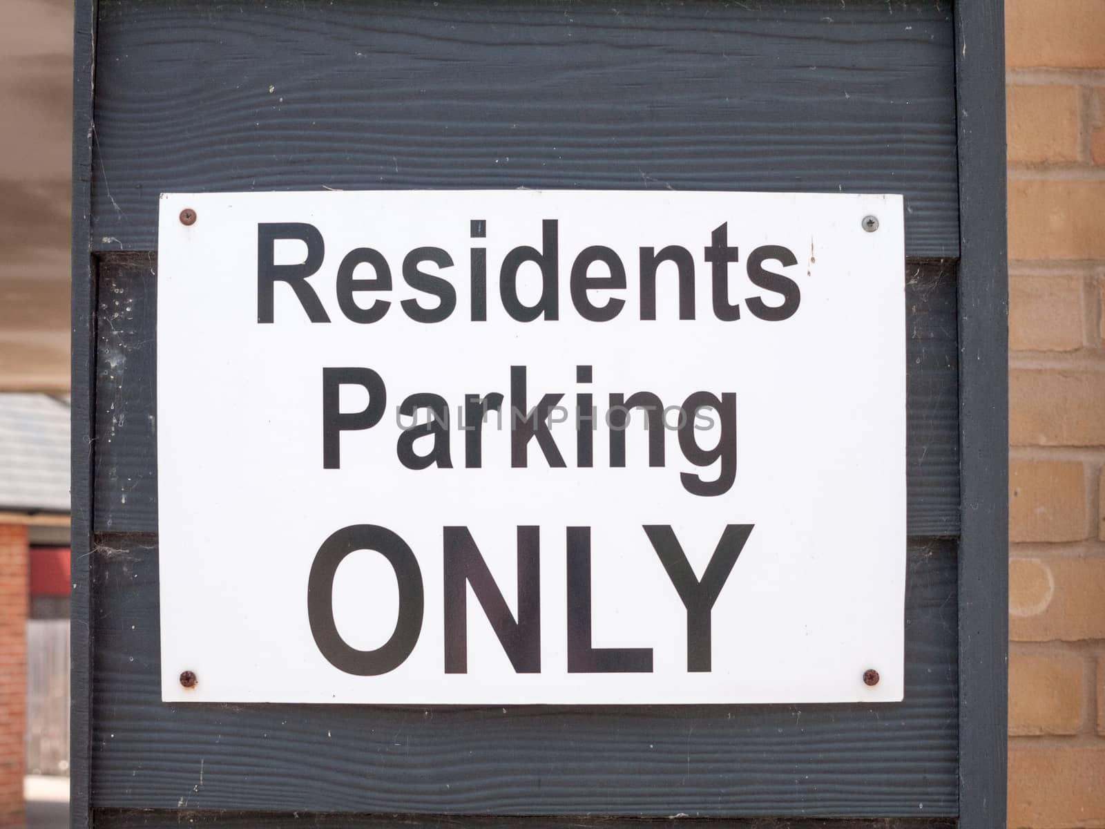 a black and white residents parking only sign