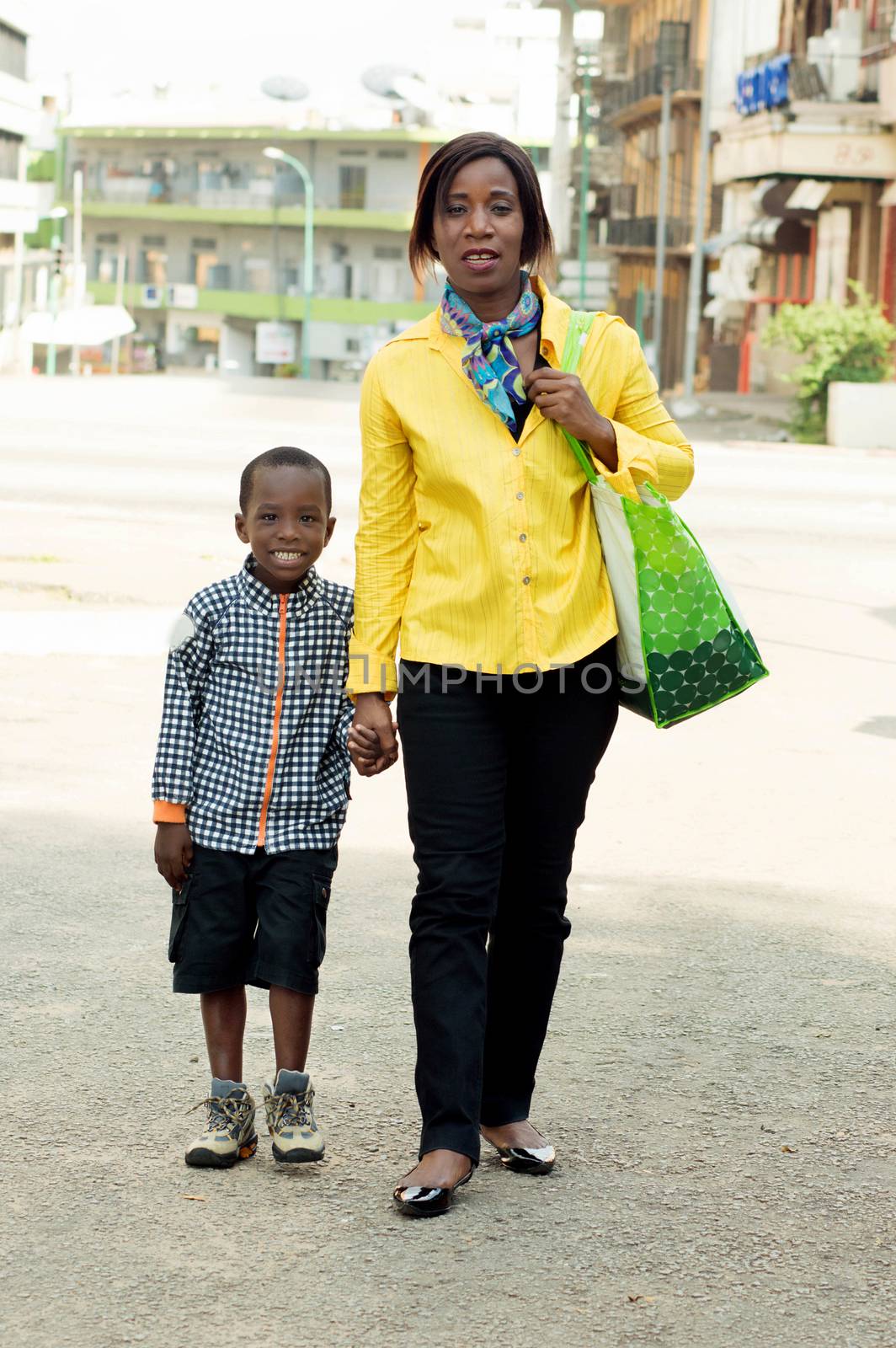 This young woman and her child ride in the street.