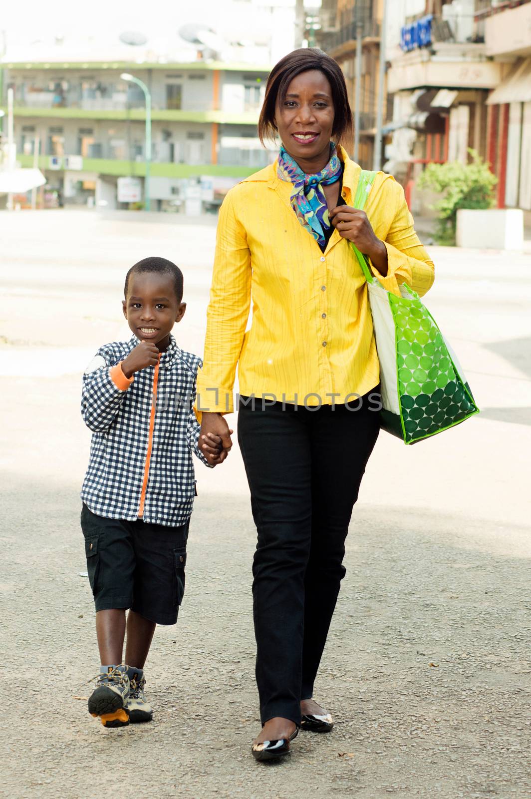This young woman and her child ride in the street.
