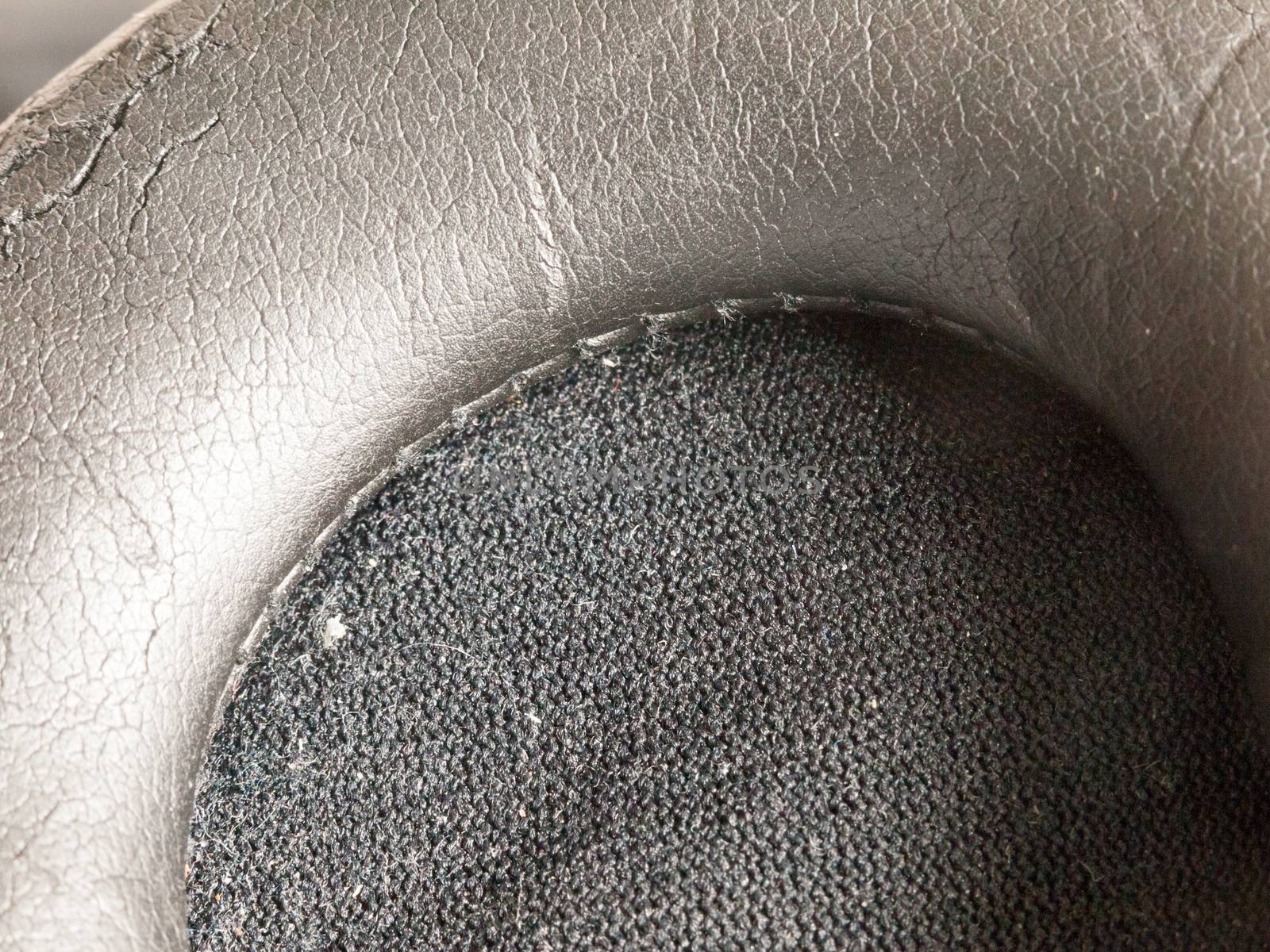 black texture of a headphone earbud up close macro