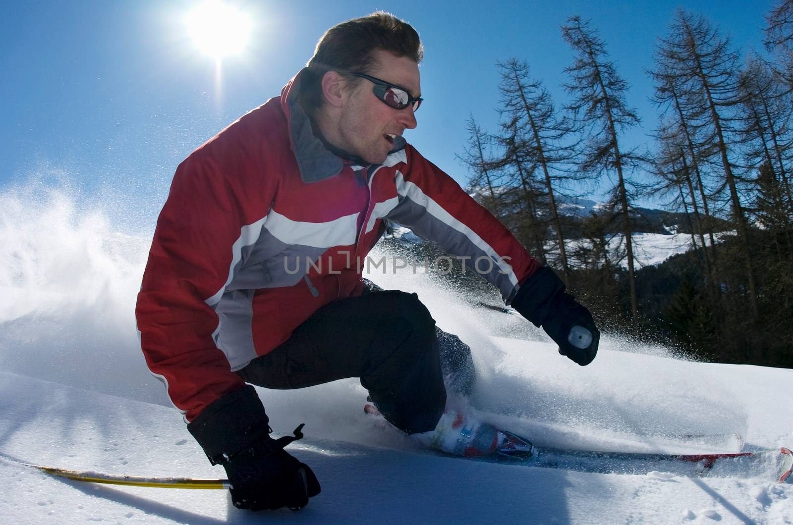 Skier carving through powder snow