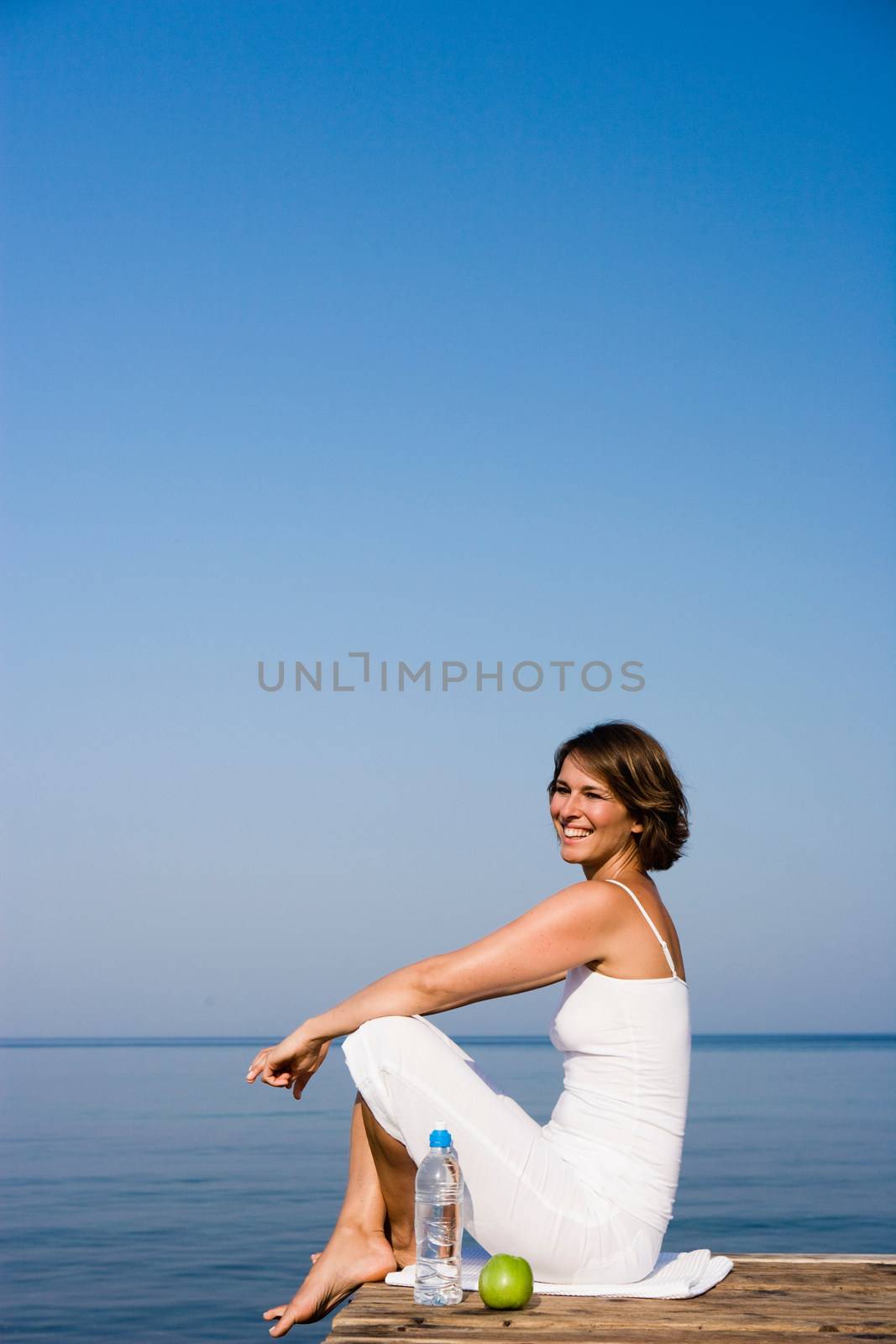 Woman sitting on a pier