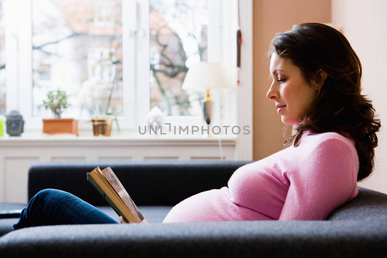 Pregnant woman reading a book