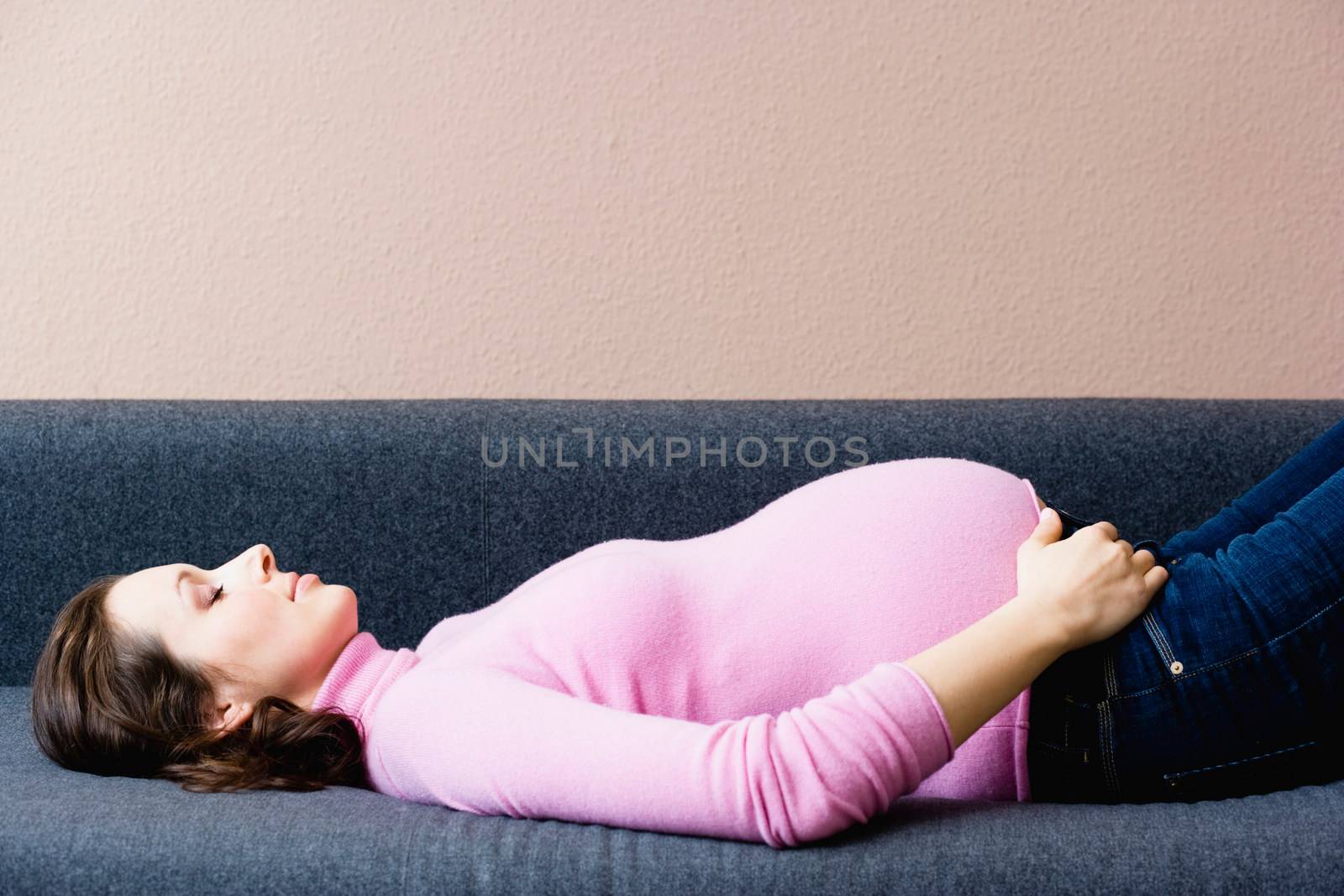 Pregnant woman laying on couch