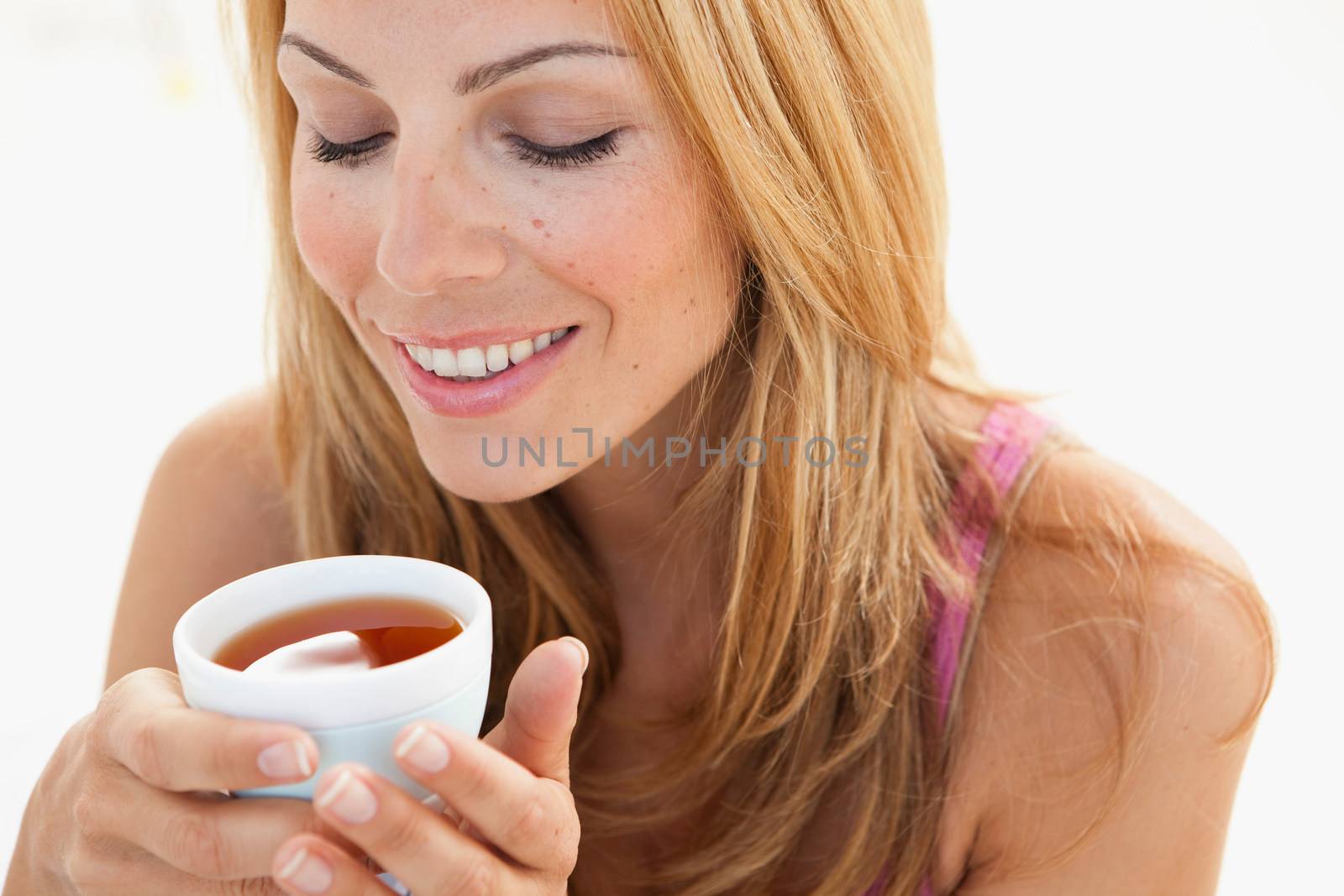 young woman enjoying cup of tea