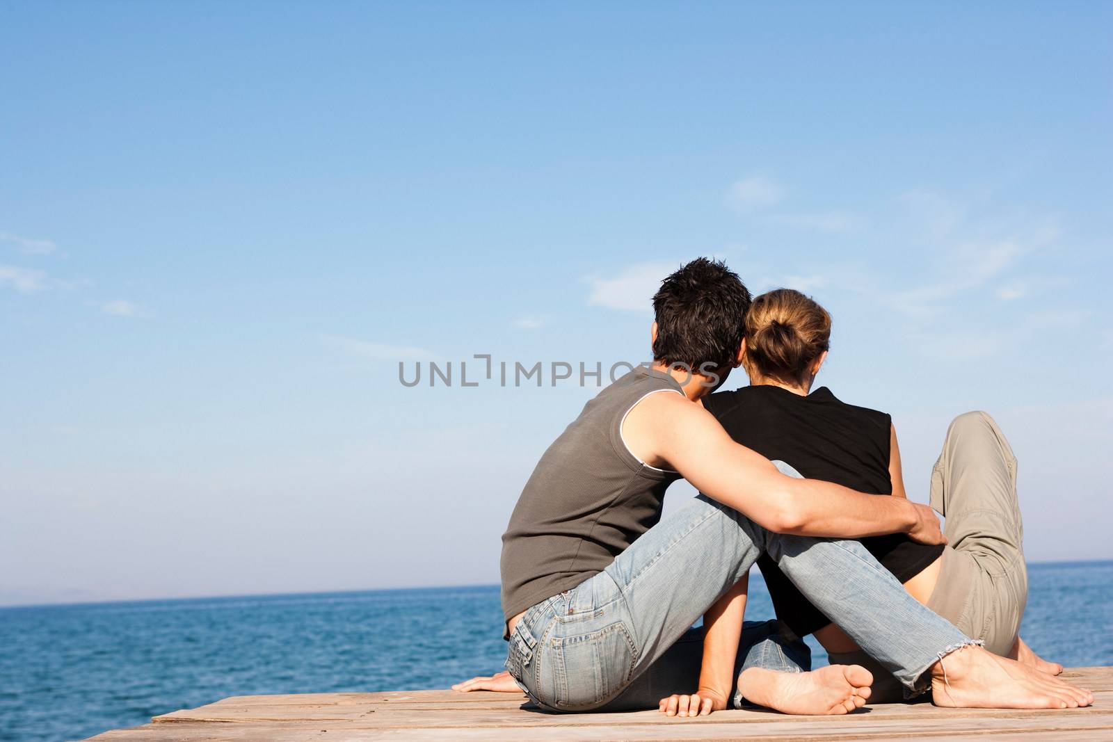 Couple Sitting On Pier