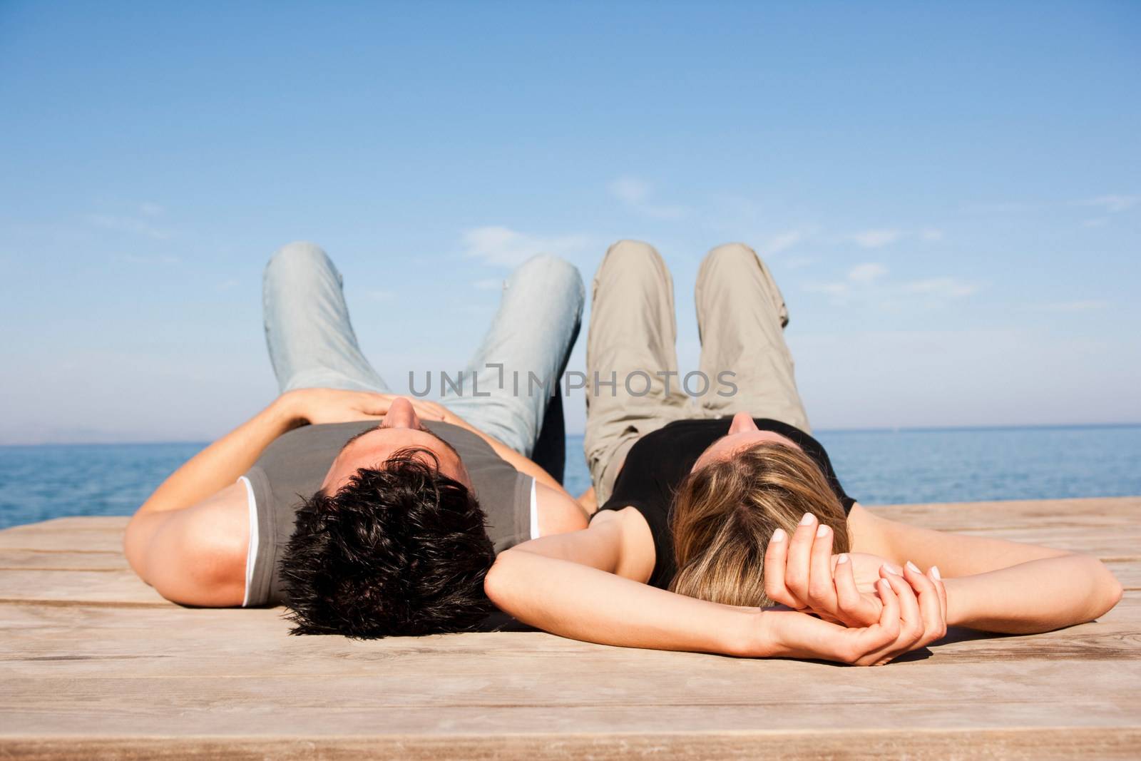 Couple Relaxing On Pier