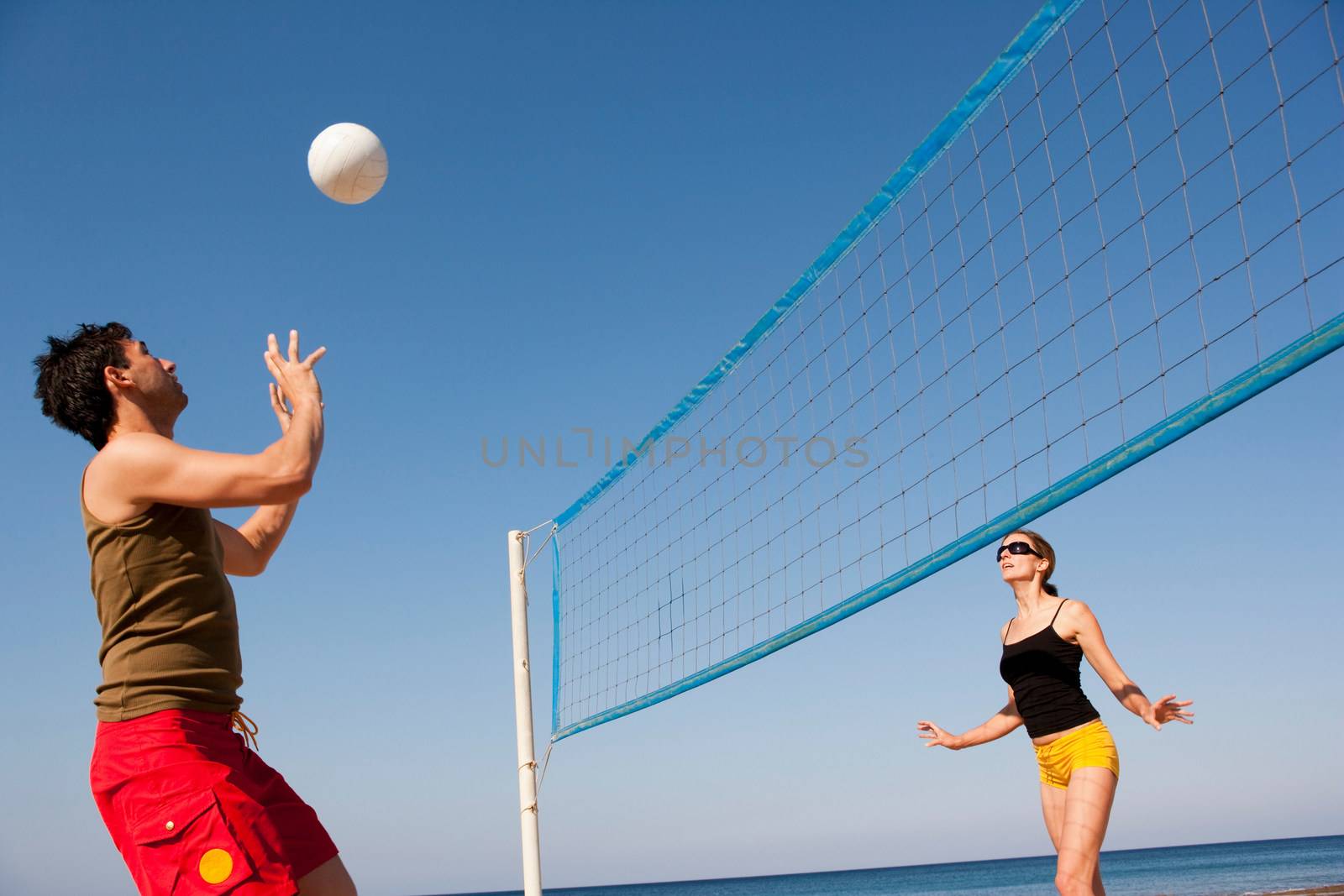 Couple Playing Beach Volleyball