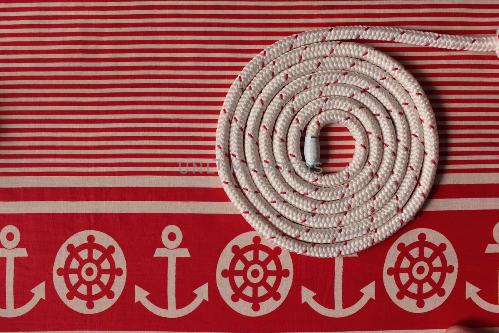 Rope round spiral red striped  flat lay Marine background