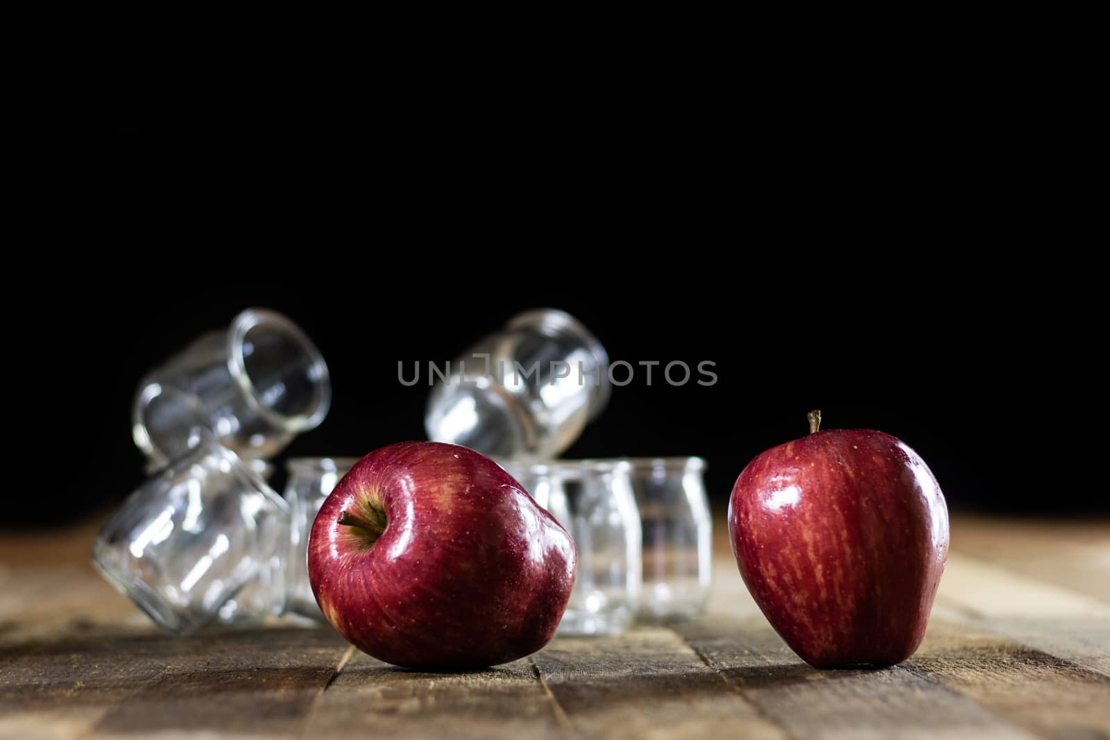 Mortar on a wooden table and empty jars, black background