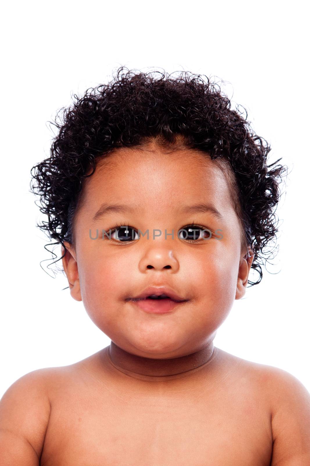 Face of beautiful cute baby toddler with curly hair.