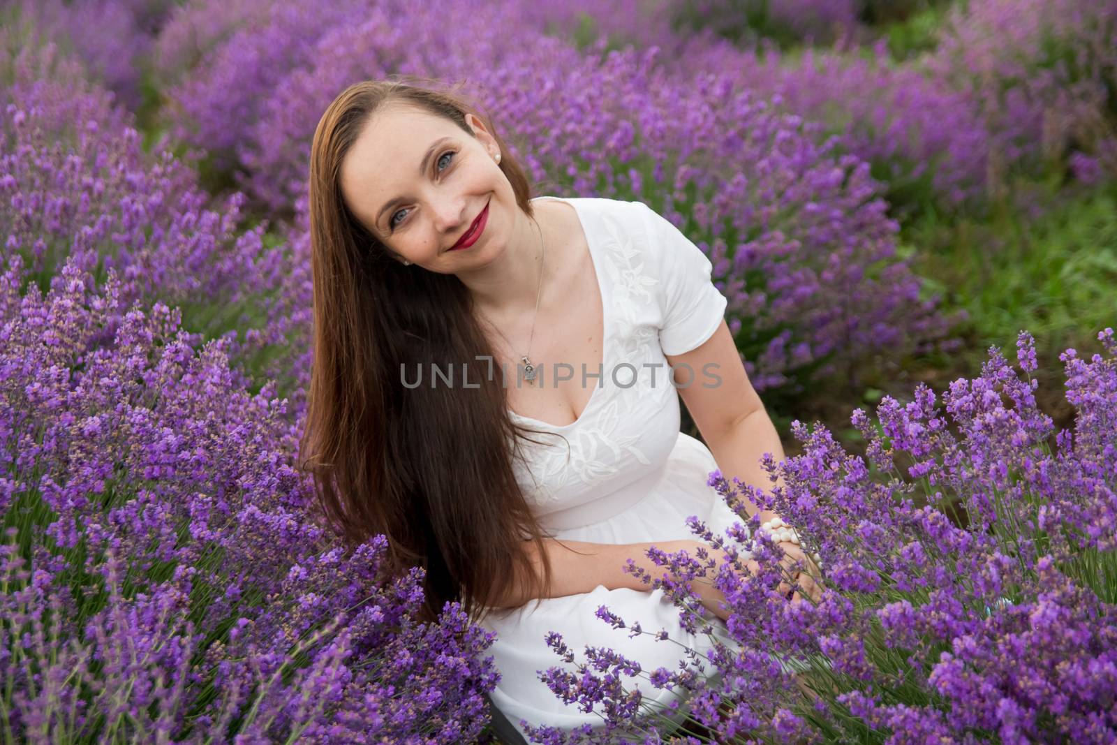 Smiling woman among lavender field blossom