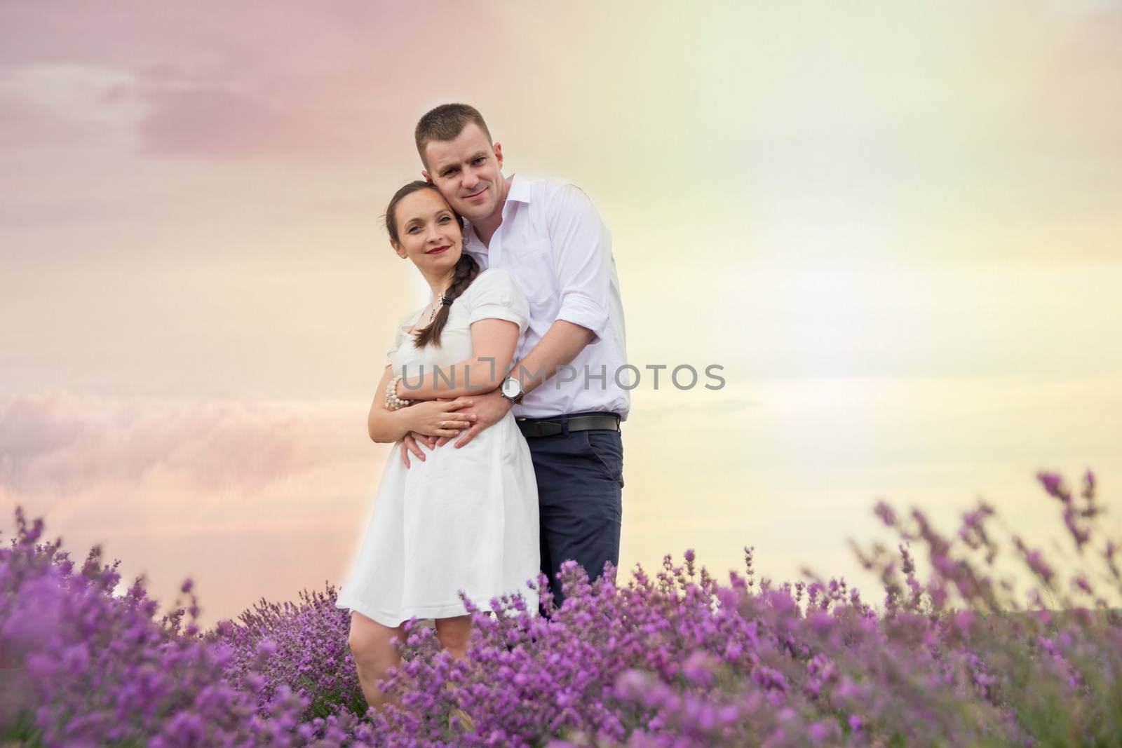 Beautiful couple hugging in lavender flowers by Angel_a