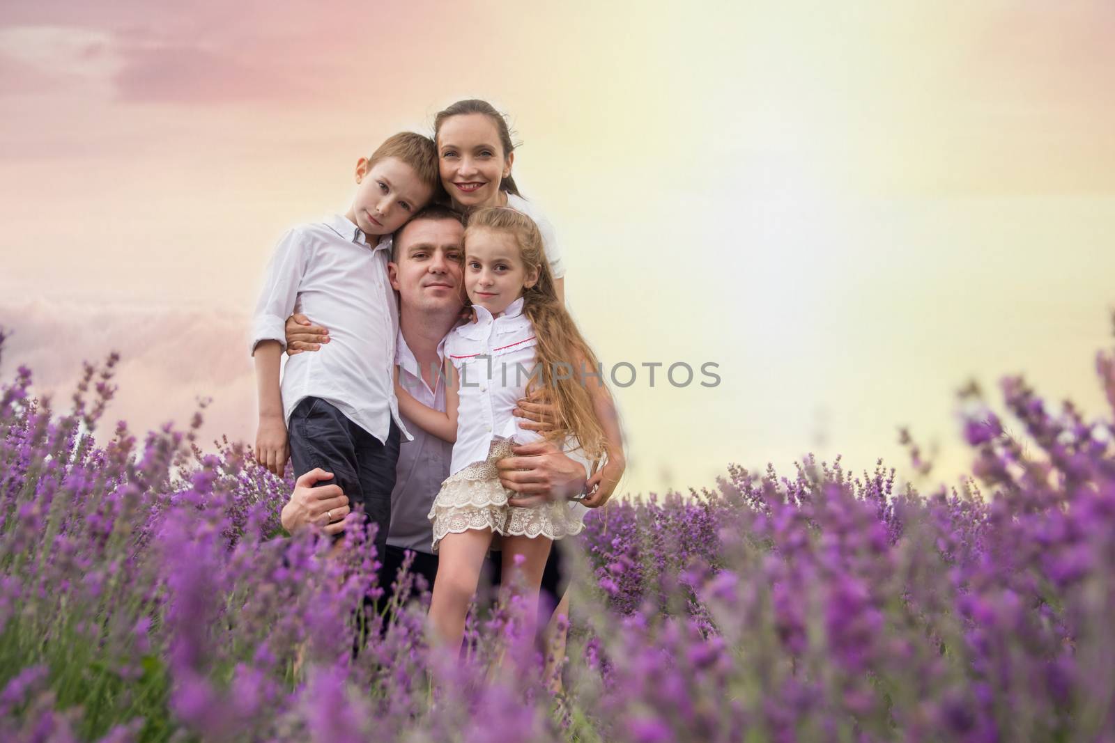 Happy family of four in lavender field by Angel_a