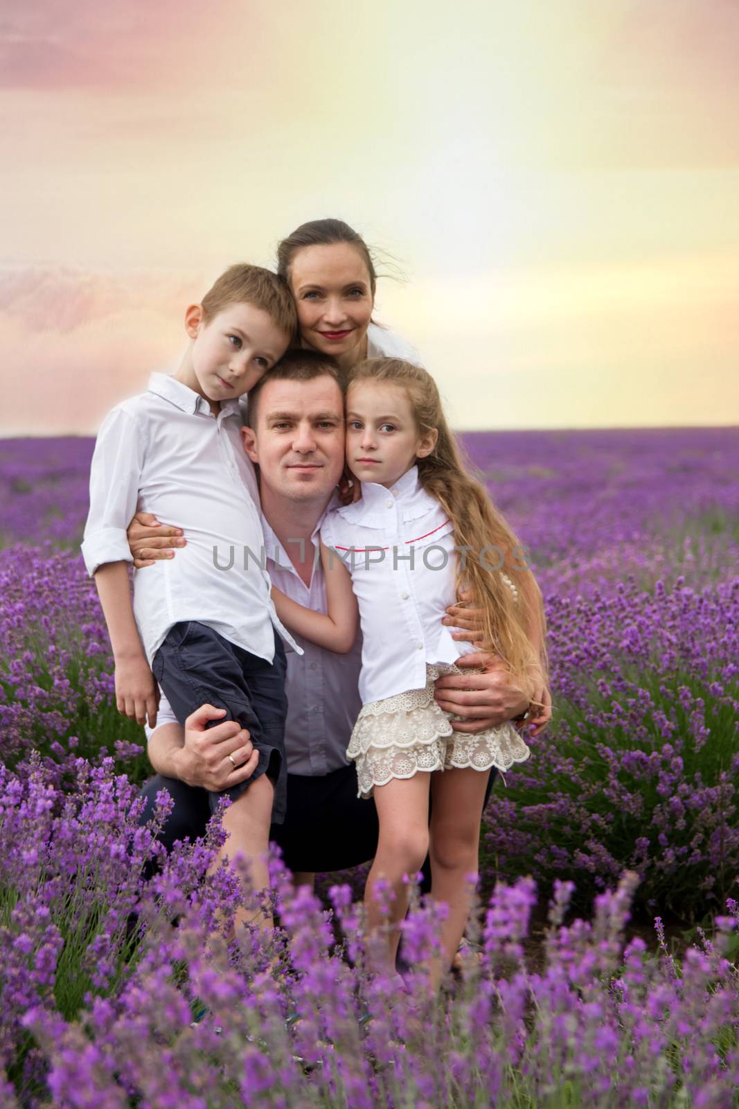 Family of four among lavender field by Angel_a