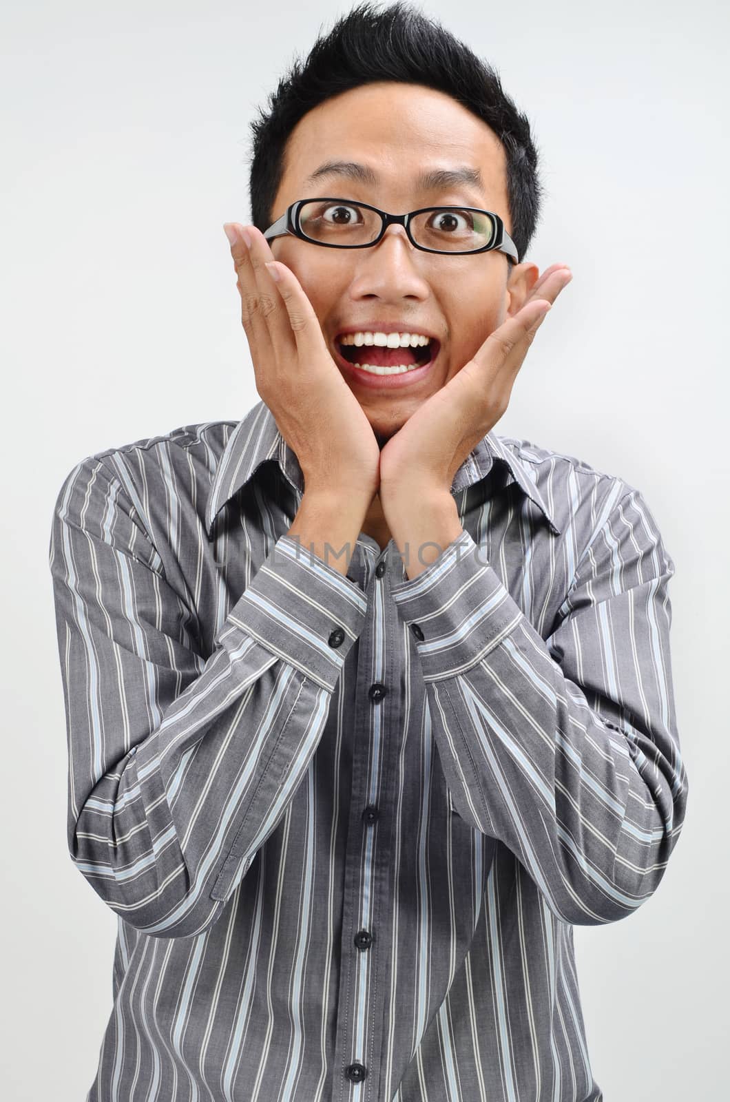 Shocked businessman portrait, Asian business man face expression, hands on cheek.