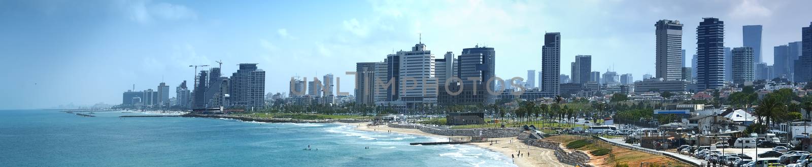 Tel Aviv skyline by day with beach, sea and waves