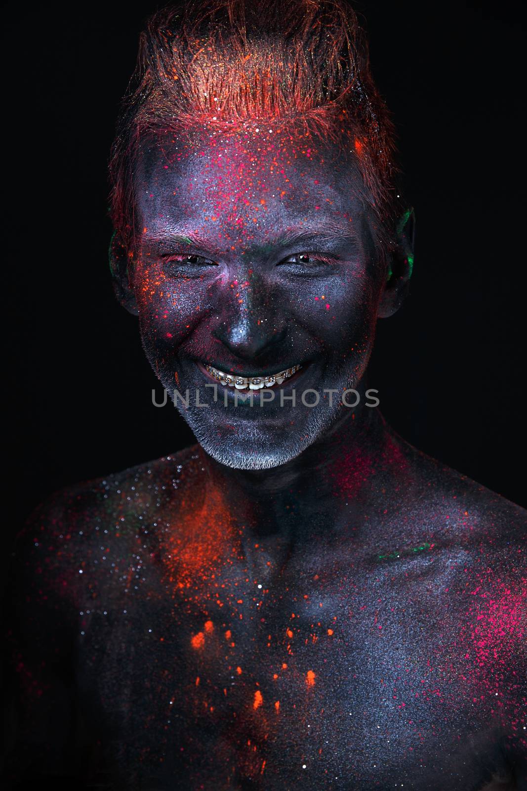 Conceptual shot of light and shine fluorescent  colors young man's face