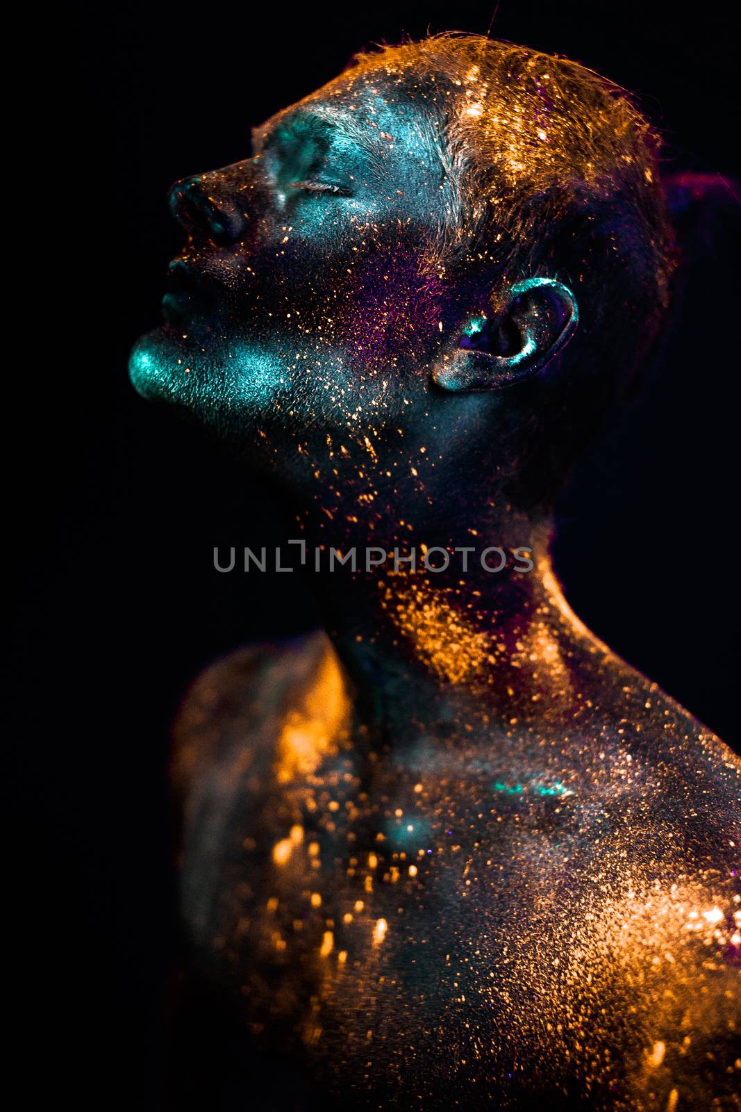 Conceptual shot of light and shine fluorescent  colors young man's face