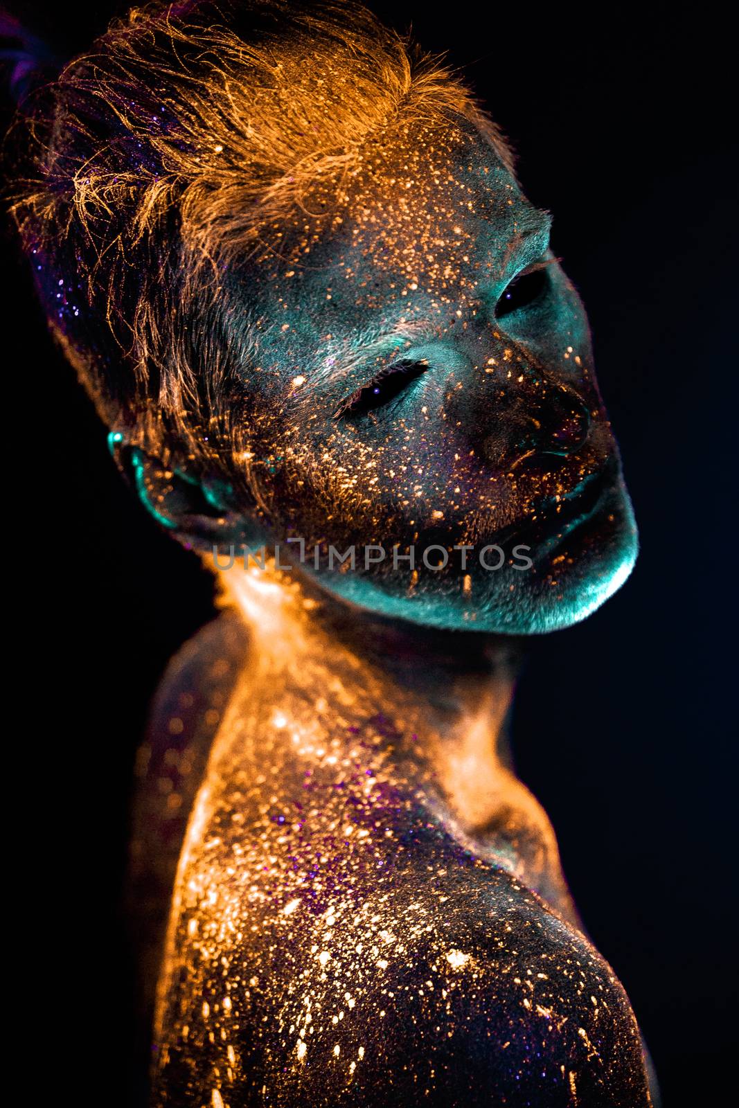 Conceptual shot of light and shine fluorescent  colors young man's face