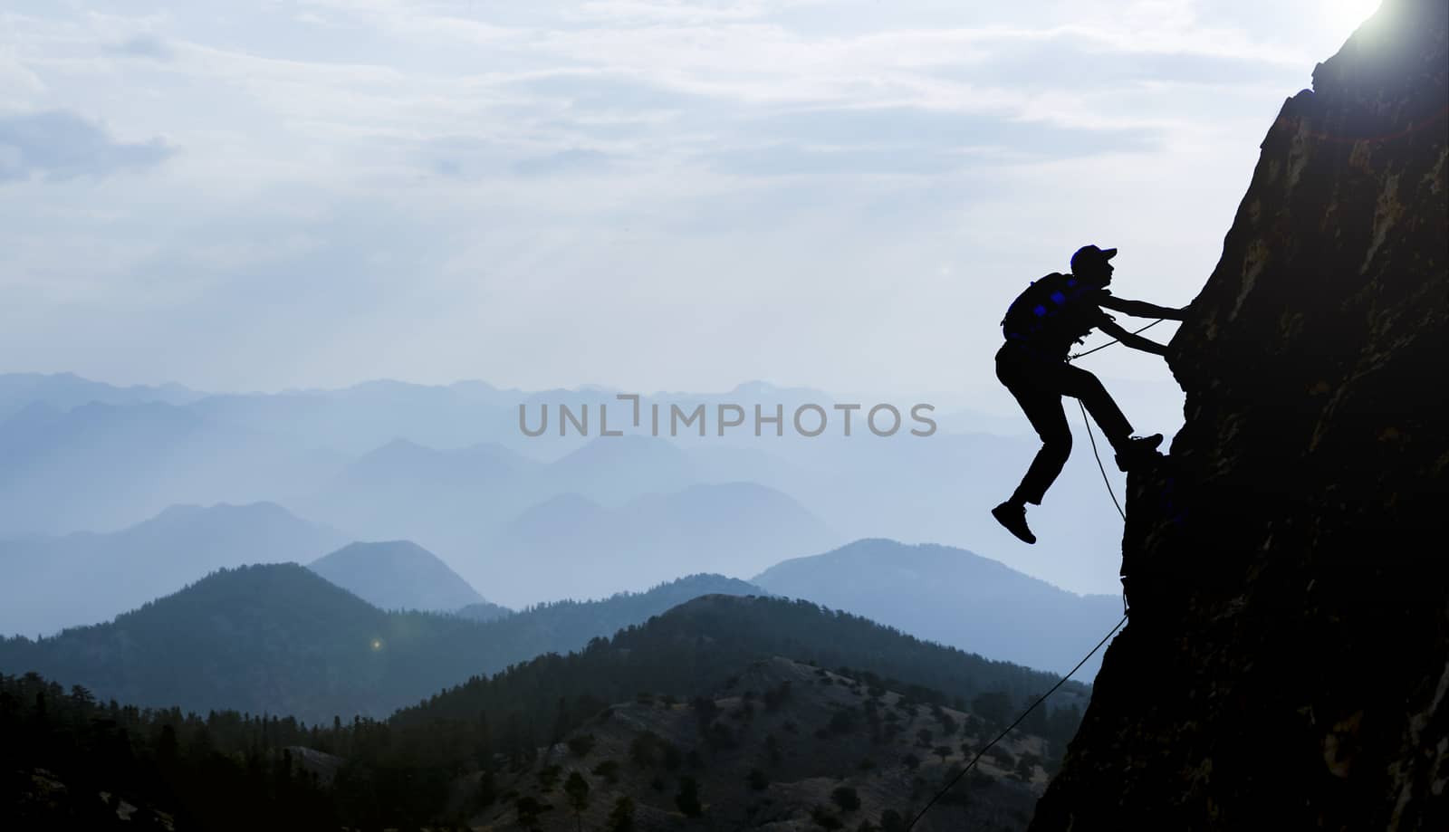 silhouette of a rock climber