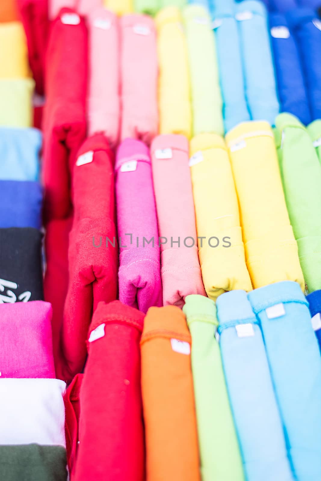 Multicolored fabric in outdoor market, colorful mixture of sever by rakoptonLPN