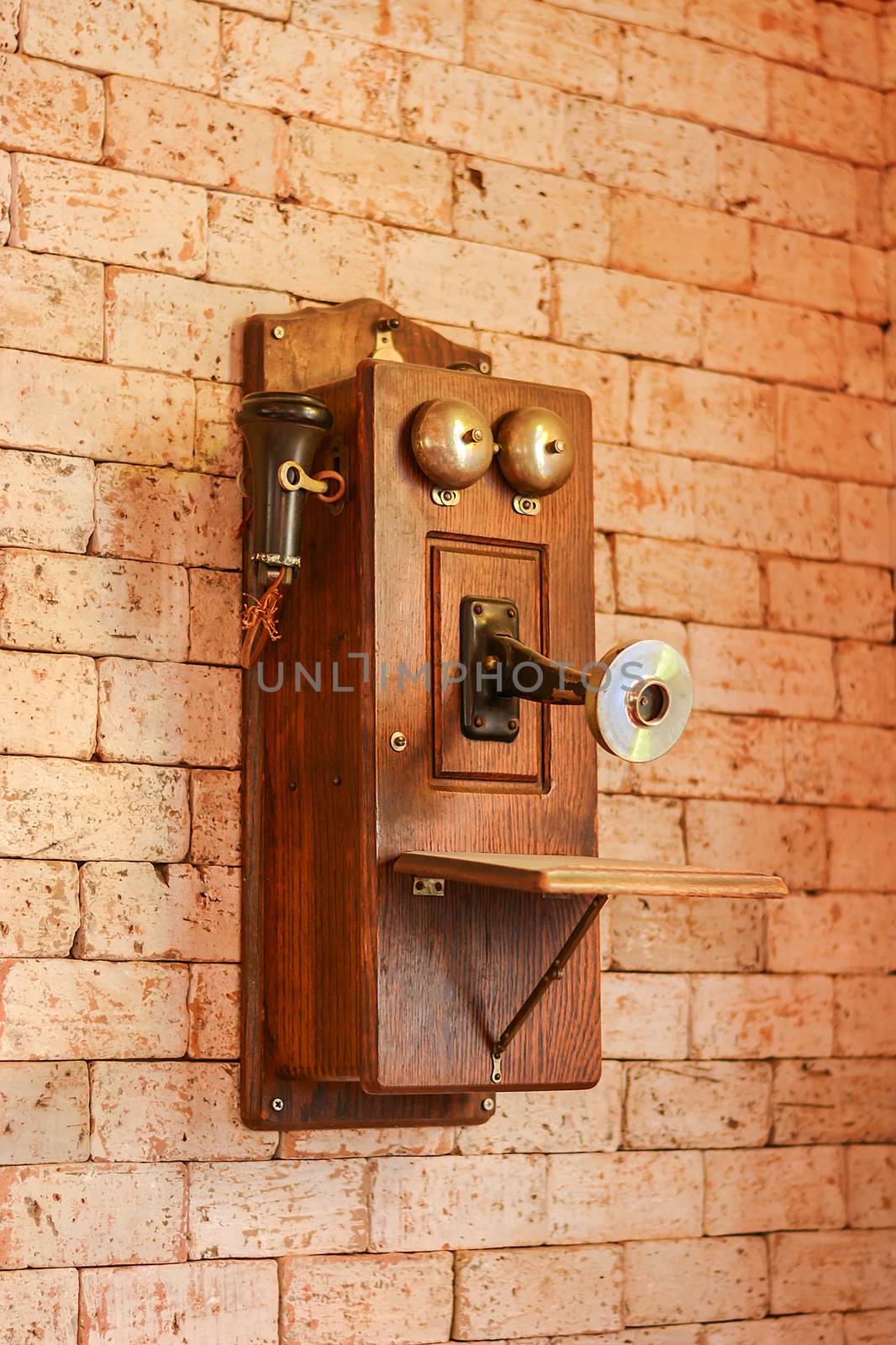Antique wooden telephone, Vintage Telephone on grungy background of a brick wall, Retro Phone