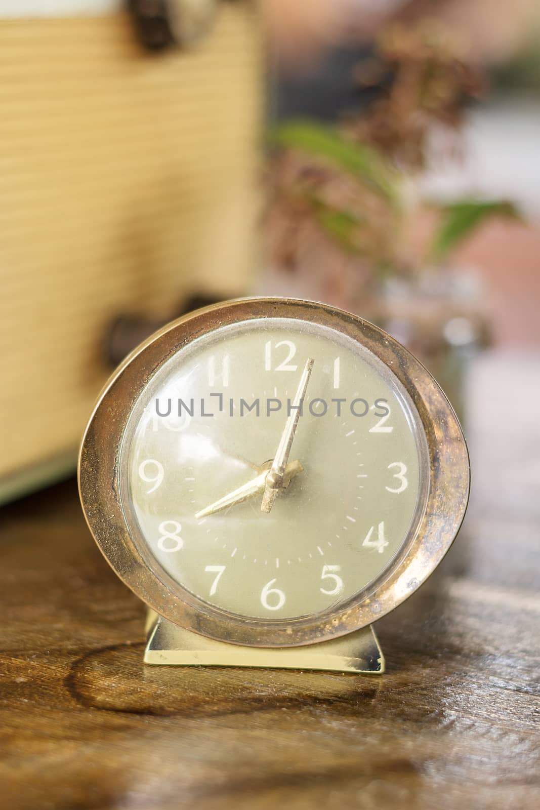 old nostalgic alarm on a table, Retro alarm clock on a table. Photo in retro color image style, vintage style