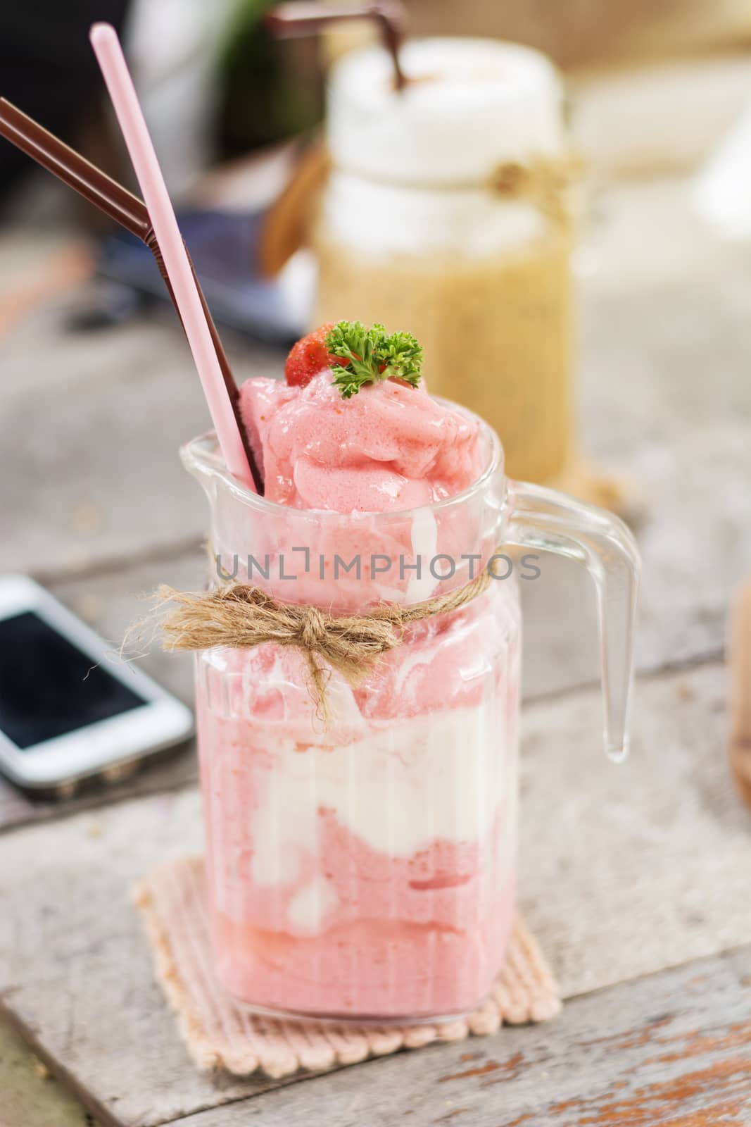 Strawberry smoothies in glass for summertime, selective focus on by rakoptonLPN