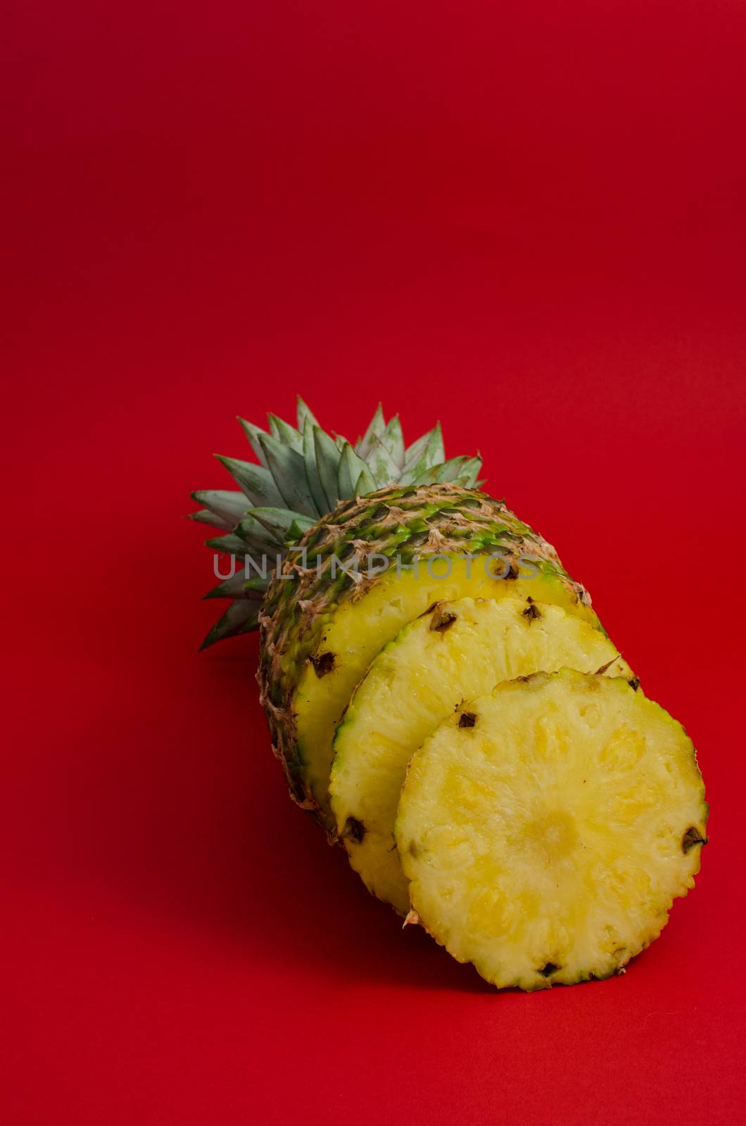 pineapple fruit on red background, circle slices