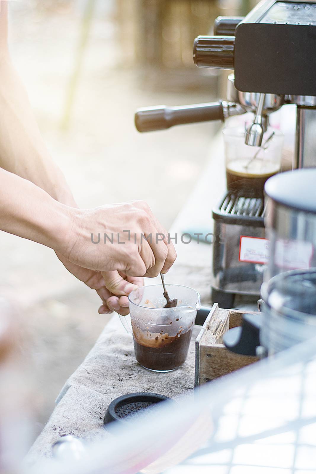 Barista mixing milk and chocolate on espresso machine for making by rakoptonLPN