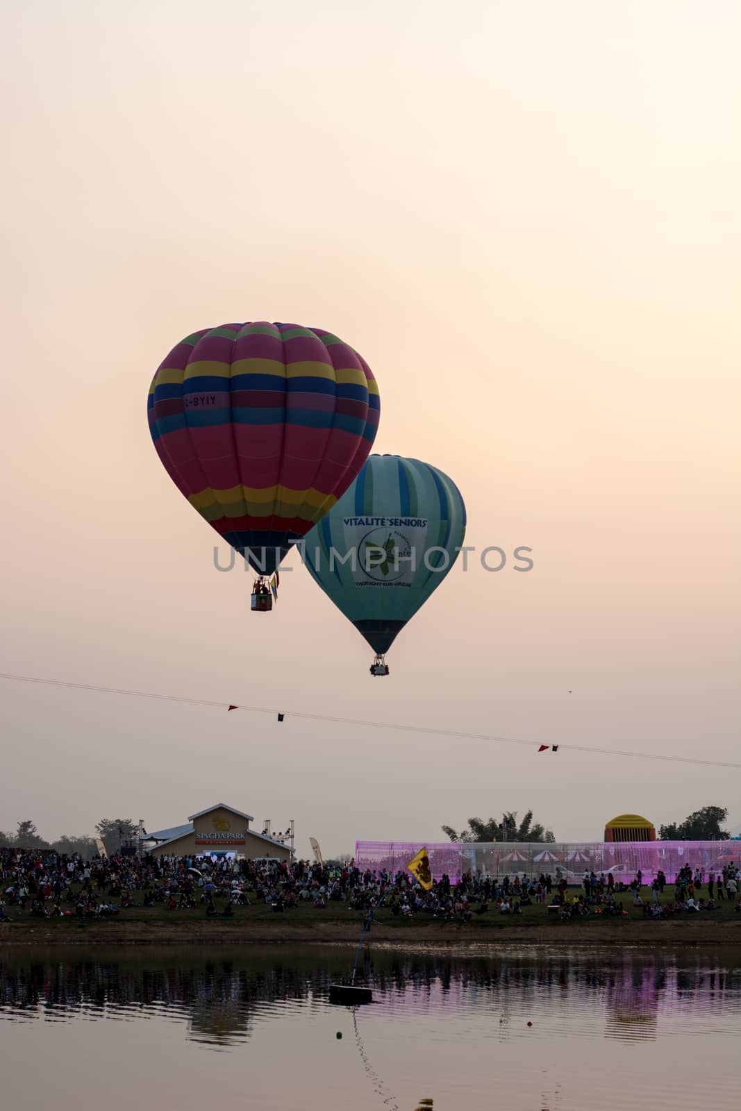 CHIANGRAI, THAILAND - FEBRUARY 14, 2016 : Hot air Balloons ready to rise into the sky in the evening at SINGHA PARK CHIANGRAI BALLOON FIESTA 2016, Chiangrai province, Thailand