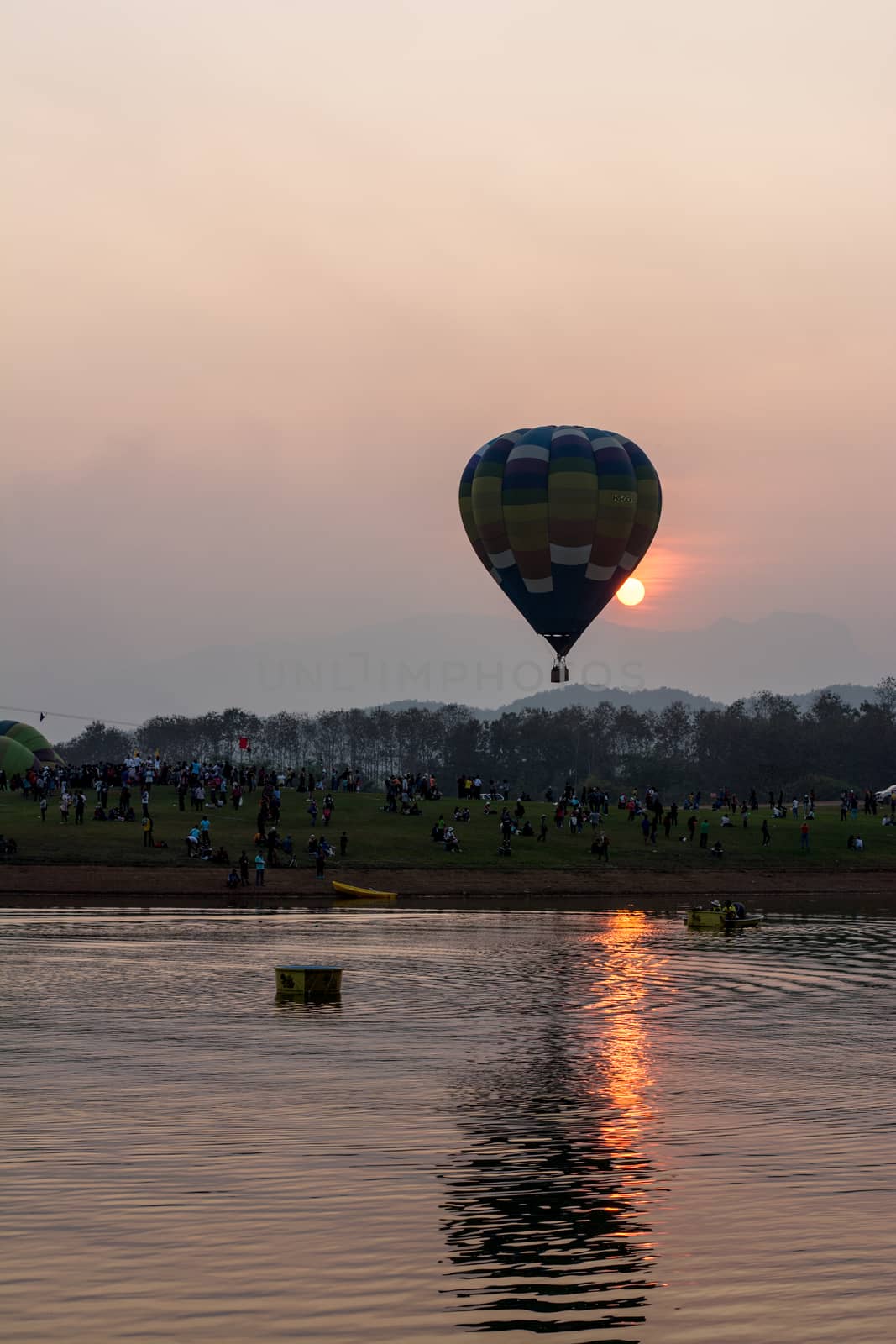 CHIANGRAI, THAILAND - FEBRUARY 14, 2016 : Hot air Balloons ready to rise into the sky in the evening at SINGHA PARK CHIANGRAI BALLOON FIESTA 2016, Chiangrai province, Thailand