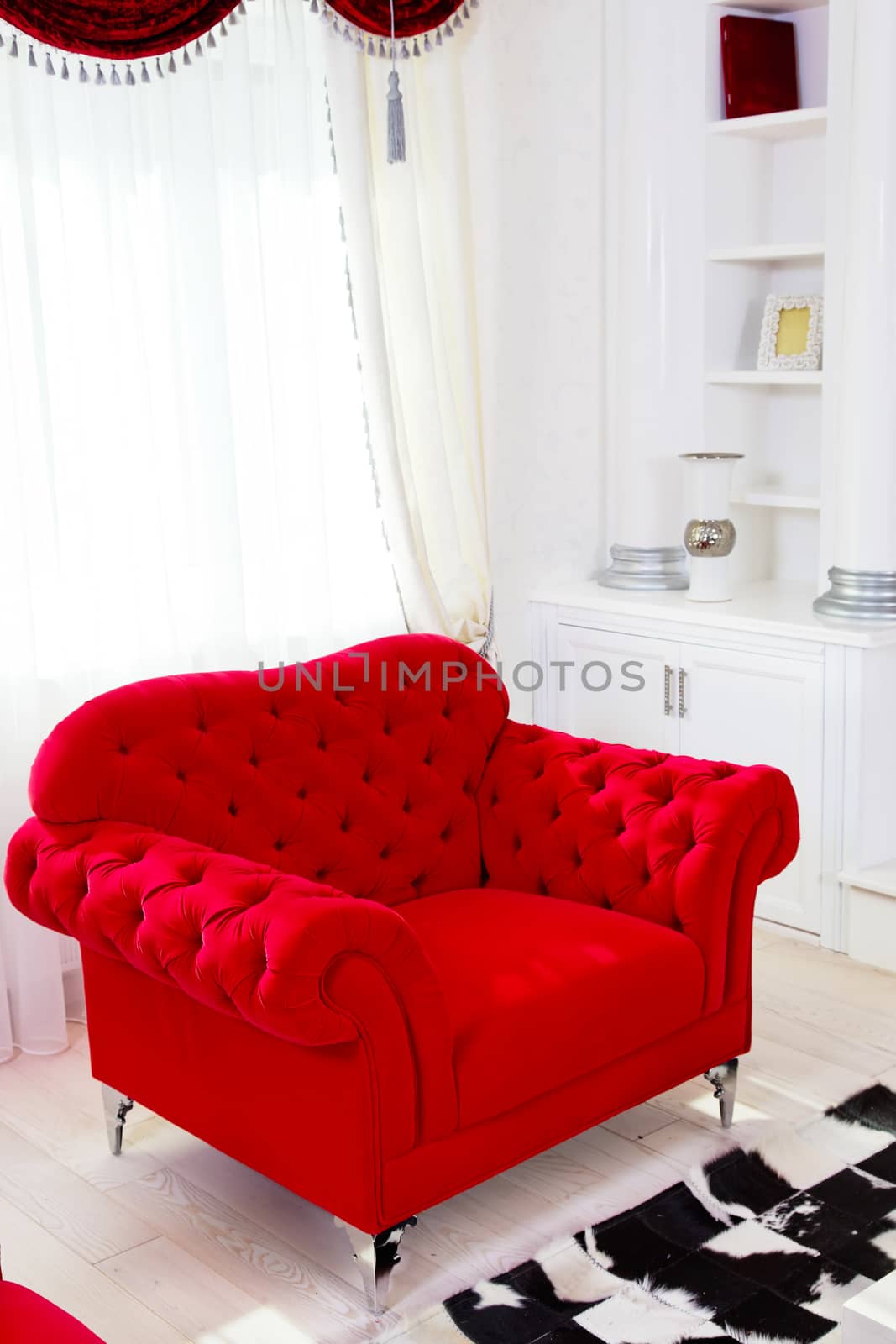 Red classical armchair and white curtains in interior