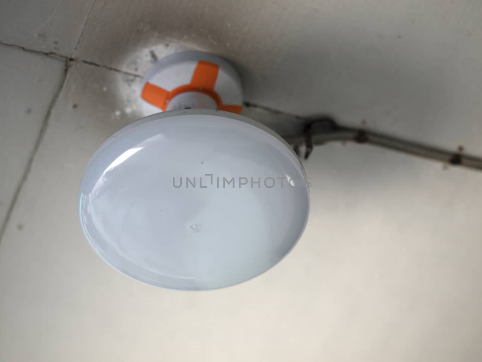 COLOR PHOTO OF CLOSE-UP OF ROUNDED CEILING LIGHT